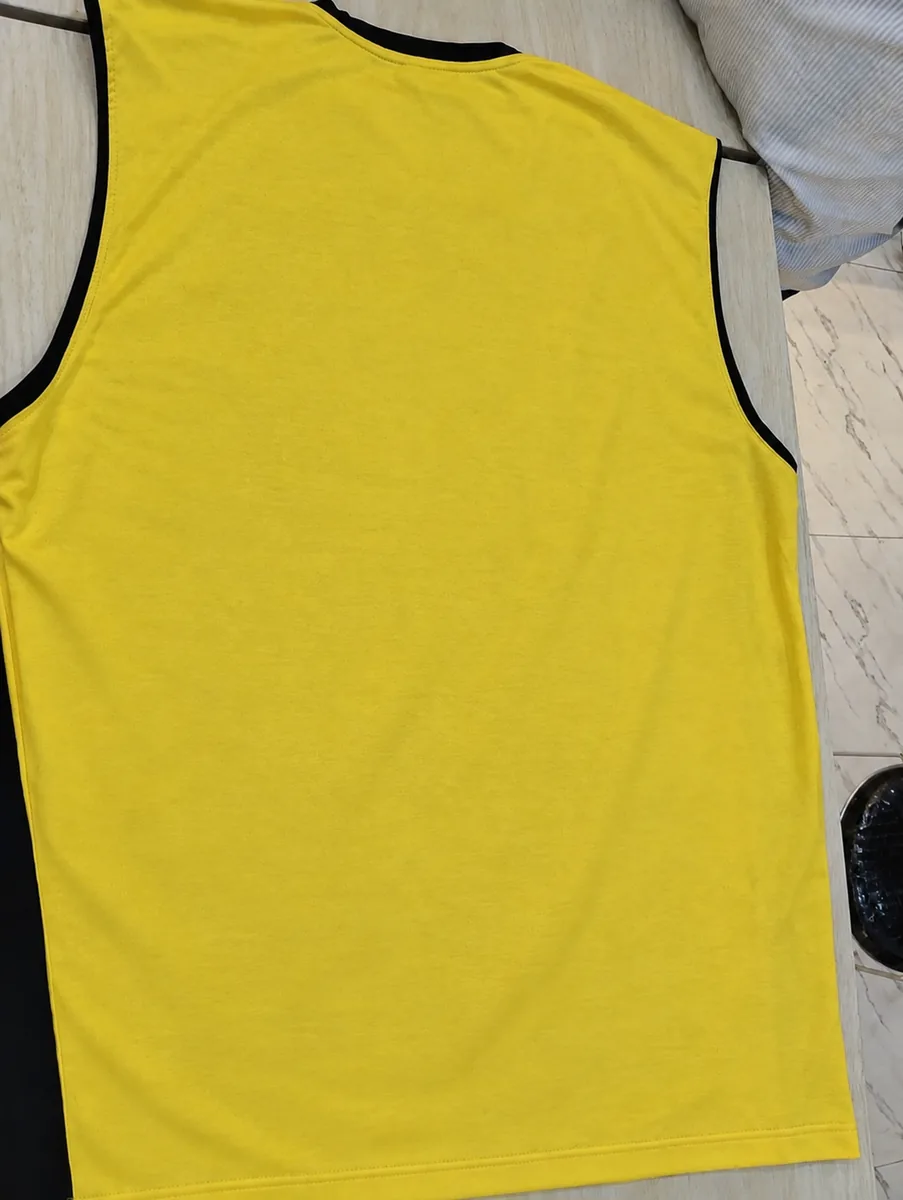 The same yellow sports vest after Wash4You cleaning