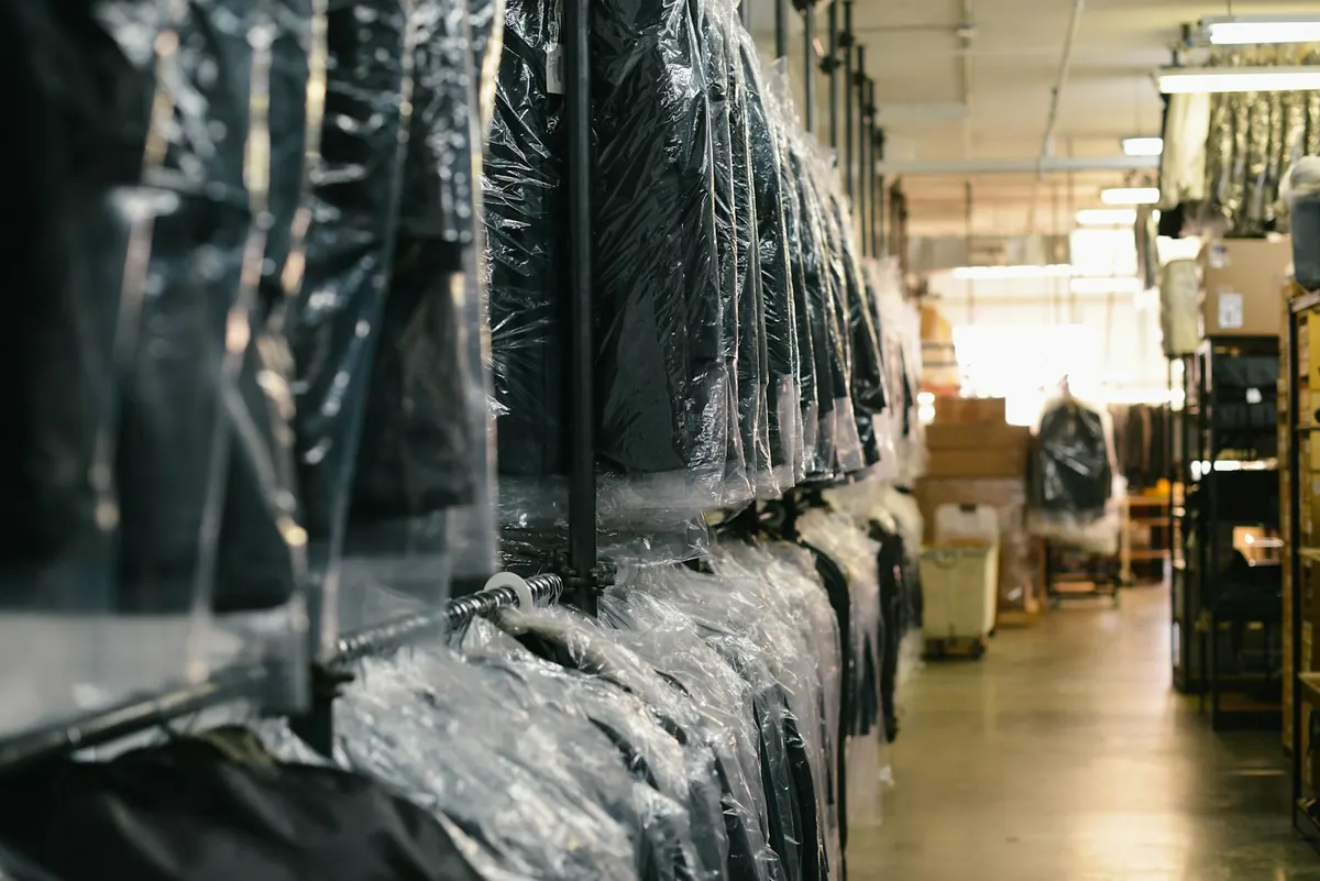 Rows of cleaned garments hanging in protective covers