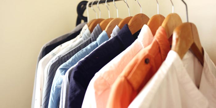 Professional dry cleaning and gentle fabric care methods being used on shirts and suits to maintain clothes quality and prevent long-term wear and damage
